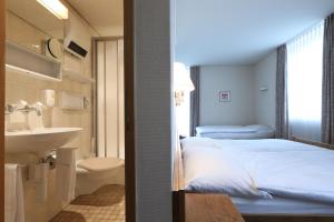 Postel nebo postele na pokoji v ubytování Hotel Concordia