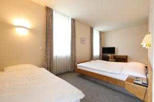 Postel nebo postele na pokoji v ubytování Hotel Concordia