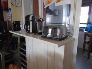 a counter with a toaster and other appliances on it at Albergue Victoria in Cirueña