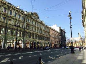 a city street with buildings and people walking on the sidewalk at Sonata Nevsky 5 Palace Square in Saint Petersburg