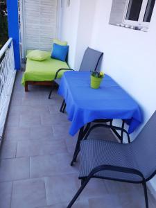 a blue table and chairs on a balcony at Villa Riviera in Stavros