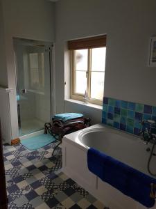 a bathroom with a bath tub and a shower at Victoria Farm in Lutterworth