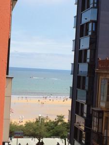 a view of a beach from a building at Living Gijon & Parking in Gijón