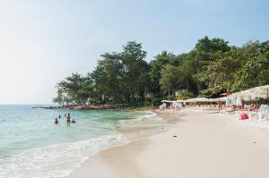 a group of people in the water on a beach at Samed Villa Resort in Ko Samed