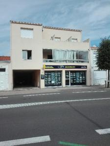 a large white building on the side of a street at Les Sables d'Olonne in Les Sables-dʼOlonne