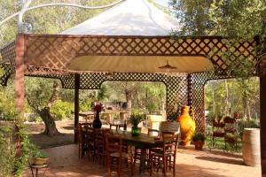 a patio with a table and chairs under a tent at Tenuta Le Crie in Maglie