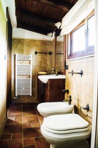 a bathroom with two toilets and a sink at Tenuta Le Crie in Maglie