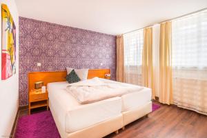 En eller flere senge i et værelse på Hotel Bayrischer Hof