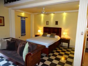 a living room with a bed and a couch at Hotel Casa Cubana Granada Nicaragua in Granada +35 photos