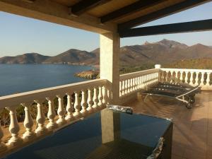 a balcony with a view of the water and mountains at Villa Saint-Michel in Galeria +53 photos