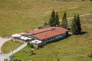 an aerial view of a building with a roof at Postalm Lodge in Seidegg