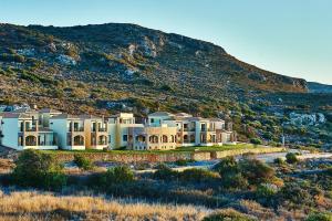 a large house in front of a mountain at Element Hotel in Elafonisos