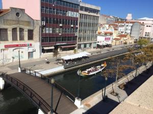 a bridge over a river with a boat in it at Aveiro Panoramic in Aveiro