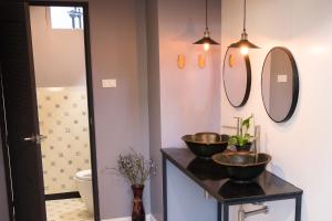 a bathroom with two sinks and mirrors on the wall at 18 In Town Homestay in Chiang Mai +101 photos