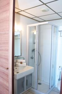 a bathroom with a shower and a sink and a mirror at Hotel Roc E Mare in Propriano