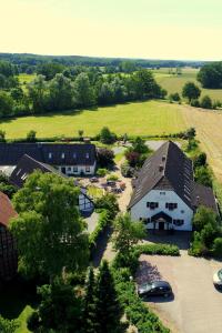 an overhead view of a large white barn with a yard at Landhotel Belitz Garni in Küsten