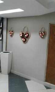 a wall with three hearts hanging on a wall at Central Lodge Hotels in Johannesburg