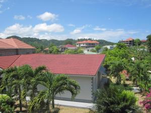 a house with a red roof and palm trees at Fairy Hill Palms in Port Antonio