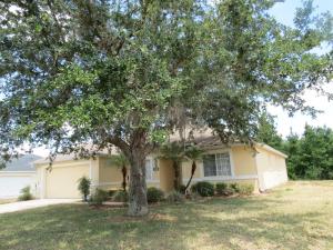 a house with a tree in front of it at 3 Bedroom Standard Davenport Home FL 33897 in Orlando