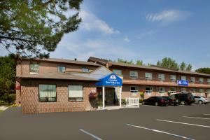 a hotel with a parking lot in front of it at Canadas Best Value Inn-Richmond Hill in Richmond Hill