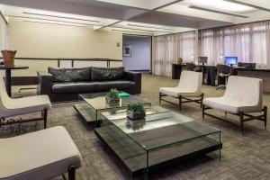 a living room with a couch and chairs and a table at Sia Park Executive Hotel in Brasília