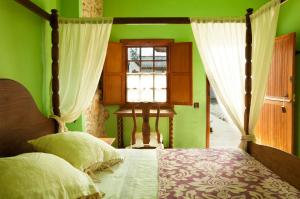 A bed or beds in a room at Hotel Rural Era de la Corte - Adults only