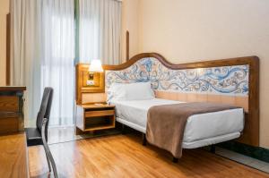 Postel nebo postele na pokoji v ubytování Hotel Julia