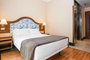 Postel nebo postele na pokoji v ubytování Hotel Julia