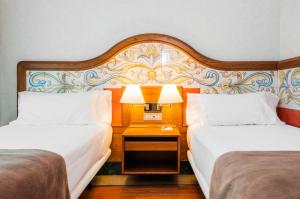 Postel nebo postele na pokoji v ubytování Hotel Julia