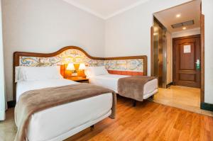 Postel nebo postele na pokoji v ubytování Hotel Julia