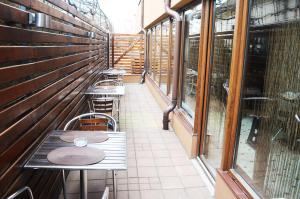 a row of tables and chairs in a room with windows at Hotel Premier in Sibiu