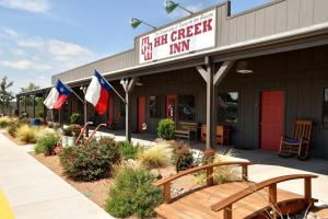 a restaurant with flags in front of a building at HH Creek Inn in Seymour