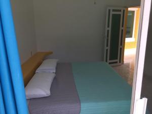 Postel nebo postele na pokoji v ubytování Residencia Jacarandas