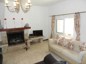 a living room with two couches and a fireplace at El Pinaret in Tarragona