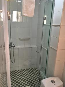 a bathroom with a glass shower with a toilet at Casa Ryan in Santiago +96 photos