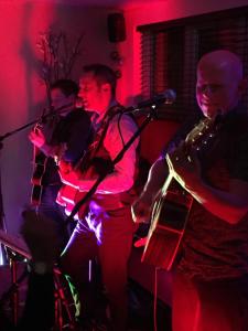 un grupo de personas tocando instrumentos en una habitación en Foundry 34 en Penrith