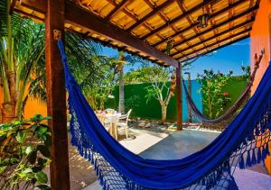 a hammock on the patio of a house at Villa Baobá Pousada & Spa in Búzios
