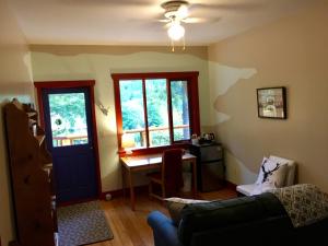 a living room with a table and a blue door at Sunshine Villa B&B in Madeira Park