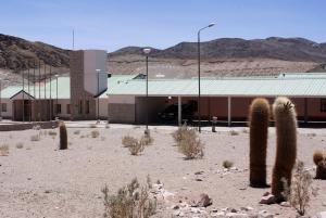 a building in the desert with cacti in front of it at Hotel de Las Nubes in San Antonio de los Cobres +30 photos