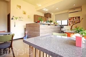 a kitchen with a counter and a island in it at 八八小屋心享民宿 in Jinning