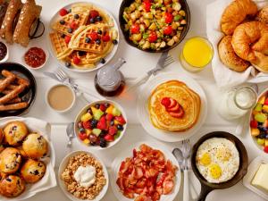a table full of breakfast foods and drinks at Petra Sella Hotel in Wadi Musa