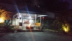 a building with a fire in the middle at night at Tea Hills Bungalow in Hatton