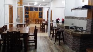 a dining room with wooden tables and chairs at Tea Hills Bungalow in Hatton