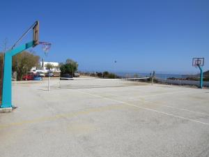 an empty parking lot with a basketball hoop at Blue Beach Villas Apartments in Stavros