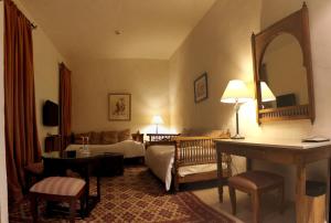 a hotel room with a bed and a mirror at Dar Saida Beya in Tozeur