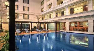 a swimming pool in the middle of a building at Fortune JP Palace, Mysore - Member ITC's Hotel Group in Mysore