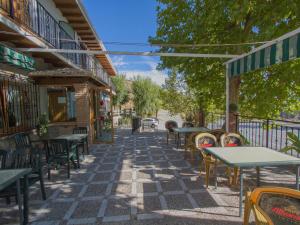a patio of a restaurant with tables and chairs at La Higuera in Güéjar-Sierra
