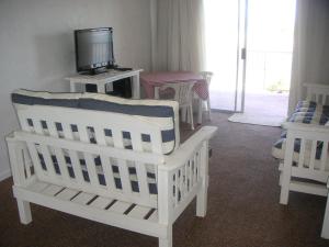 a nursery with white cribs and a tv and a room at Waterside Living DB03 in Jeffreys Bay