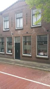 a brick building with windows and a door at Pension Groeneweg in Gouda