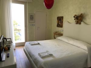 Postel nebo postele na pokoji v ubytování Hotel "La Salute"
